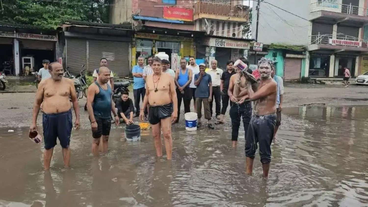 Businessmen take bath in pit