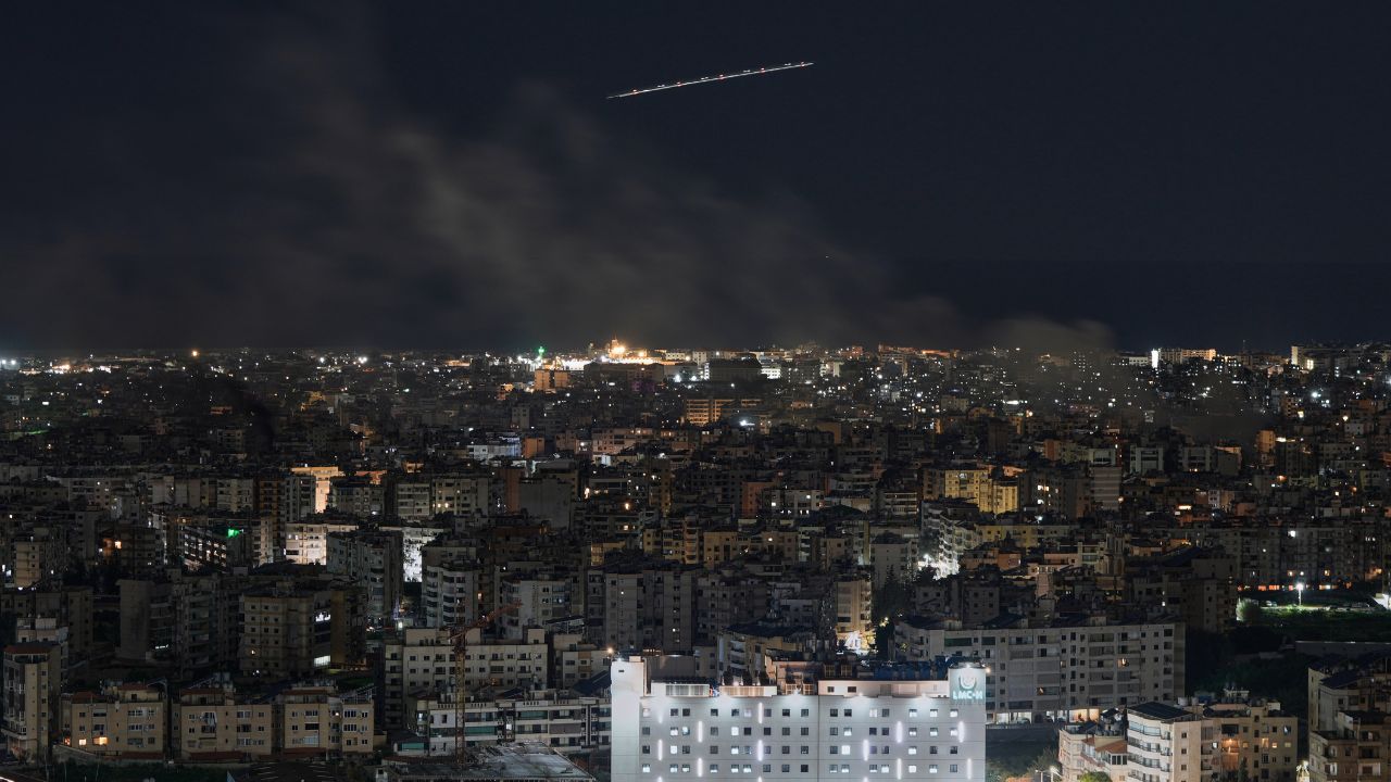 Middle East Airlines plane flies as smoke rises in Dahiyeh