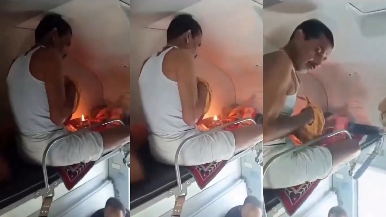 passenger performing puja with diya in AC train coach upper berth